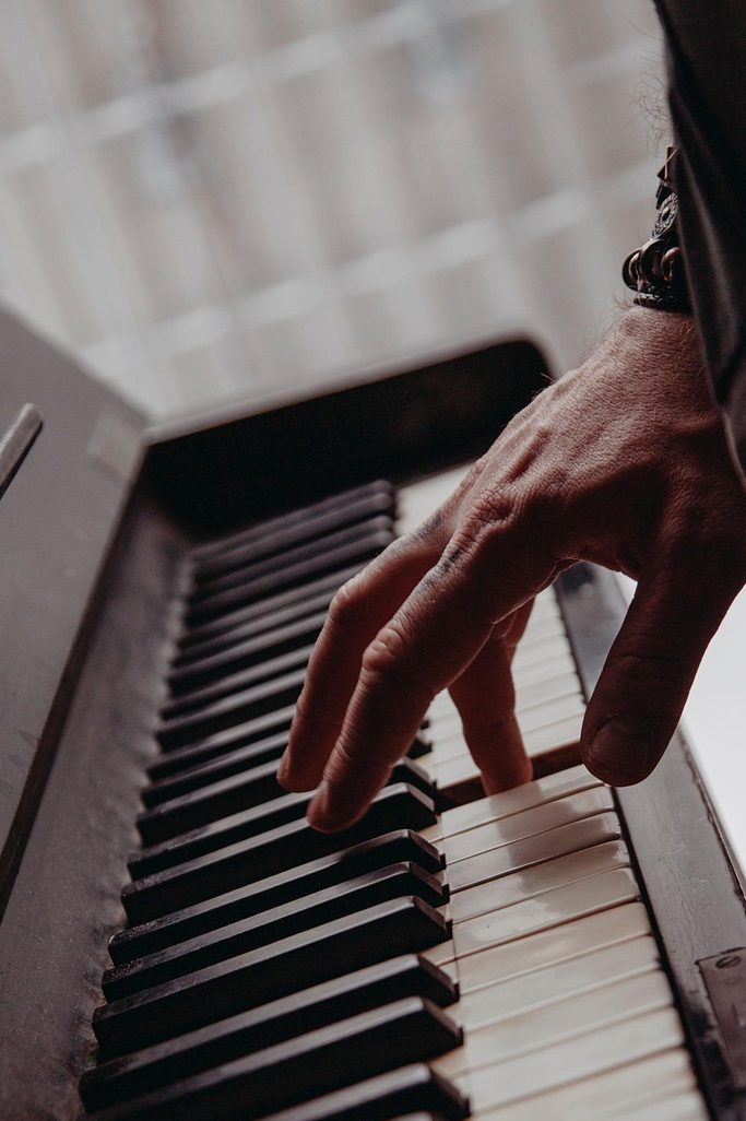 Hand playing piano keyboard | why music matters for dementia sufferers | Strensall Day Care Centre